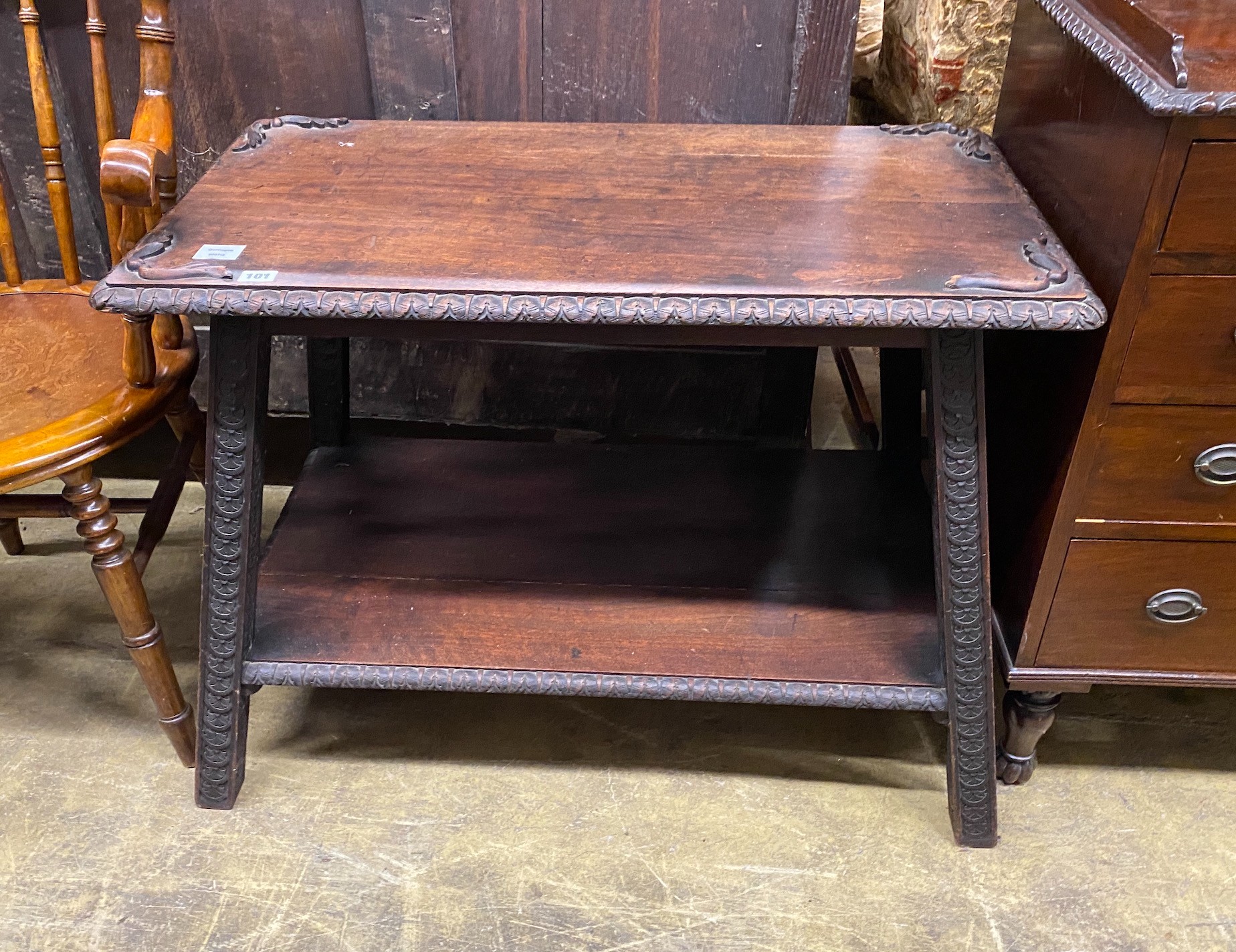 An early 20th century Continental carved hardwood two tier table, width 87cm, depth 49cm, height 64cm